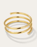 Large gold spiral bracelet on a light background