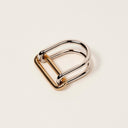 Gold and silver metal ring on a light beige background