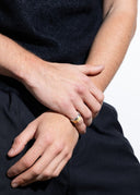 Close-up of a man's hands with a gold ring on a white background