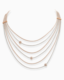 Multi-layered necklace with rose gold and silver chains on a white background