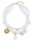 Multi-strand pearl necklace with gold charms on a white background