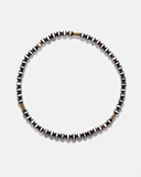 Necklace with black and white beads on a light gray background