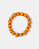 Orange beaded bracelet with gold accents on a white background