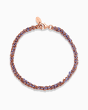 Purple and rose gold silk braided bracelet on a white background