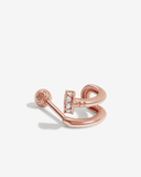 Rose gold earring with stones on a light gray background