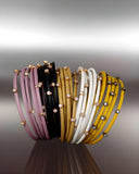 Set of colorful leather bracelets with stones on a gradient background