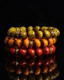Stack of colorful beaded bracelets on a black background