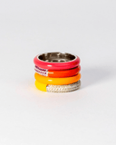 Stack of colorful enamel rings with stones on a white background
