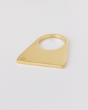 Gold triangular ring on a light gray background