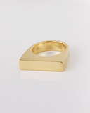 Gold ring with a geometric design on a light gray background