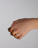 Woman's hand wearing three gold rings