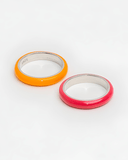 Two enamel rings, one orange and one pink, on a white background