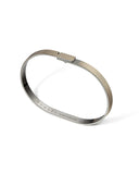 Brass bracelet with engraved text on a white background