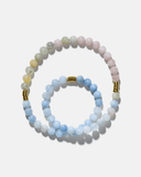 light pink and baby blue beaded necklace with gold accents on a white background